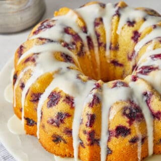 A delicious blueberry orange bundt cake with orange icing on top