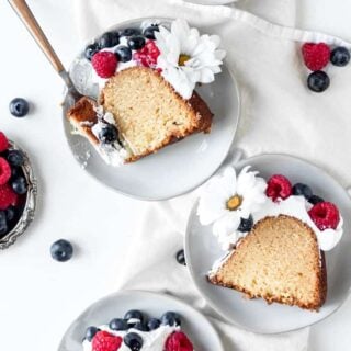 Slices of butter pound cake on white plates ready to serve